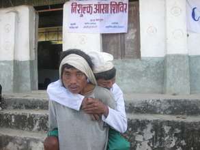 patient carried to a screening camp.