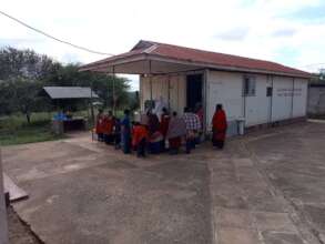 Maasai women bringing milk to sell at the dairy