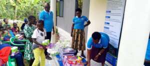 DISTRIBUTING SCHOLASTIC ITEMS TO CHILDEN.jpg