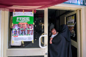 A mother and son enter a clubfoot clinic in Abuja.