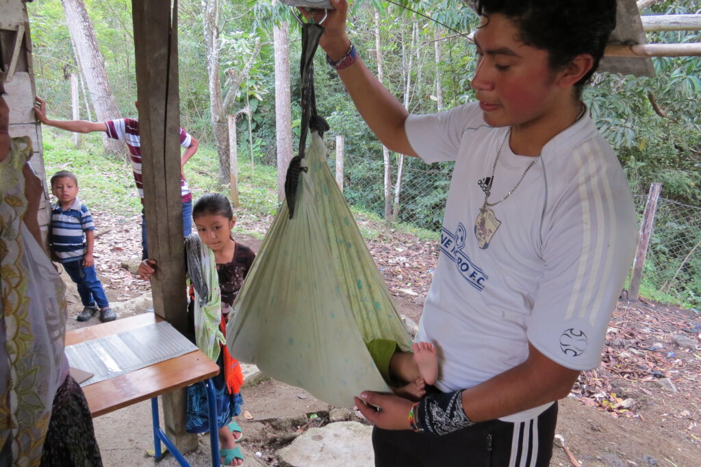Weighing child on a hanging scale