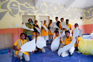 Students pose with the art for the media room.