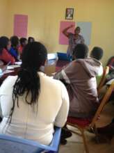 Facilitator guiding teen mothers through learning
