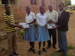Teachers handing gifts on behalf of Tanzsolar