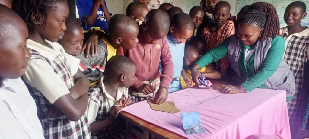 Girls being trained on how to make reusable pads