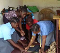 Teenage mothers learning tailoring skills