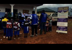 Children proudly wearing their new school kits