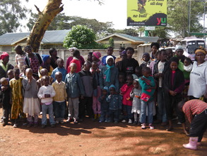 10 new mamas with their kids ready to leave Kibera
