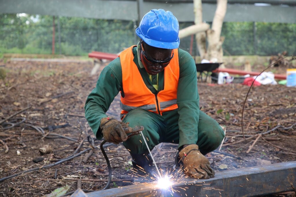 Technician welding the angle lines.