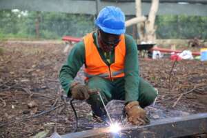 Technician welding the angle lines.