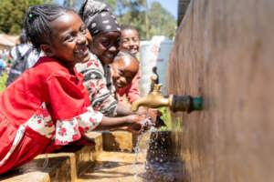 Serawit and her friends using the taps