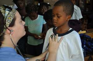 Listening to lungs at La Main Tendre Orphanage
