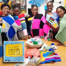 Students create wool-warm items for babies.