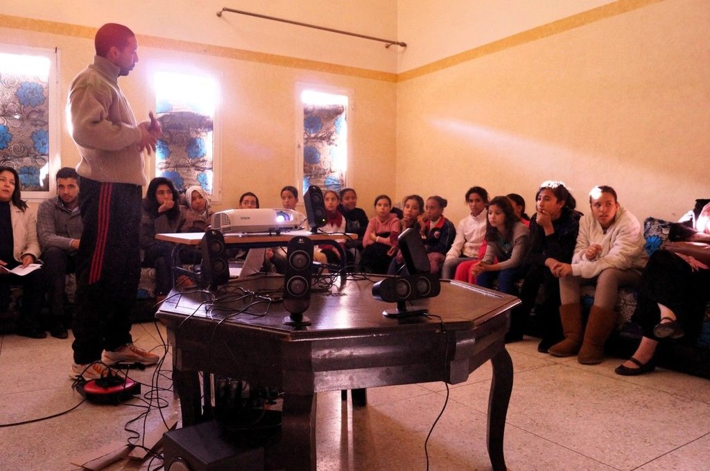 children in a meeting with their educator