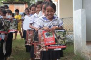 Kids show off their new educational materials