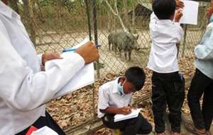 Taking notes as they meet each animal.