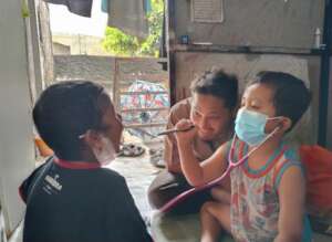 Nurse Dadan shares a moment with Kafi & his cousin