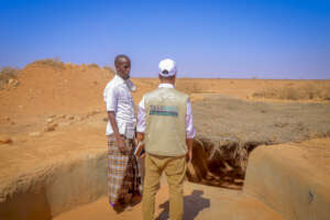 Our team & Local leader at an empty reservoir