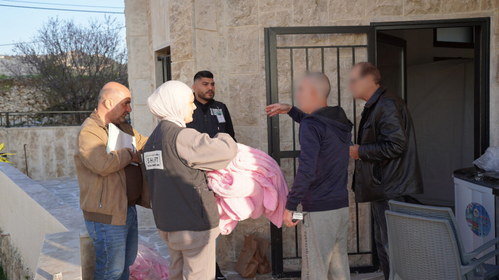 Distributing Blankets for displaced people