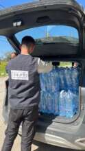SHiFT team distributing water in shelters