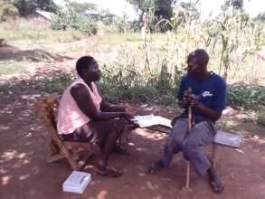 Project staff talking to Charles