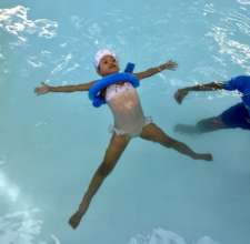Zimbongi floating with teacher nearby