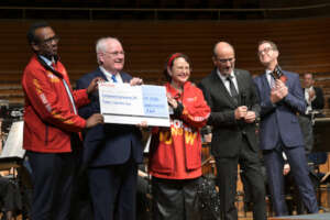 Rotary officials hold check from event in Lucerne