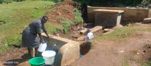 Brenda collecting water at Birirbei water spring