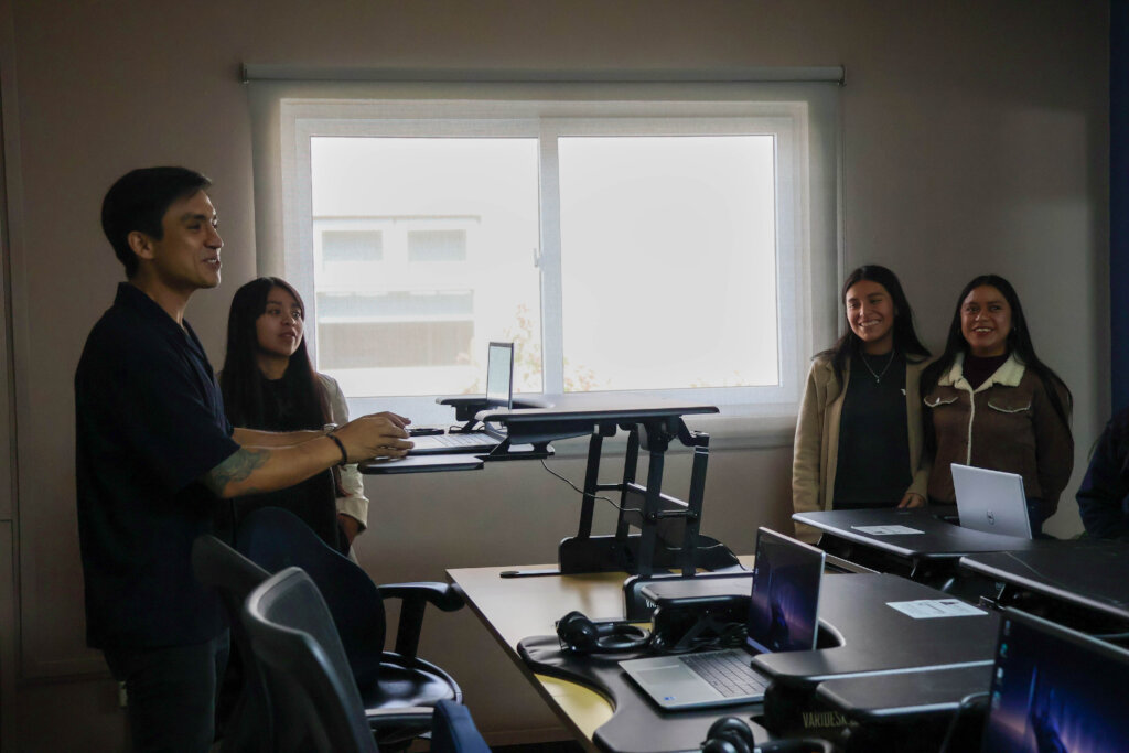 Impact Hub trainer shows off the ergonomic desks.
