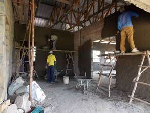 Preparing the inside of the building walls.
