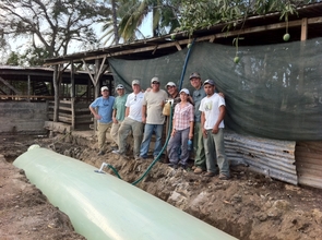 EARTH volunteers & staff with finished biodigester