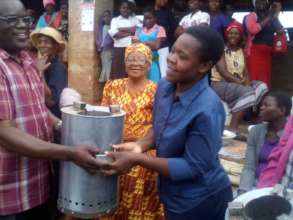Women receiving energy efficient stoves