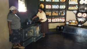 Women Showing Us The Mud Stove