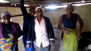Women Dancing After Receiving Chicken Feed