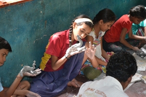 A Child appreciating her Clay model