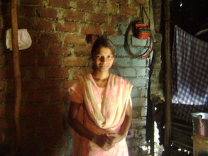 Lakshmi welcoming her Social Worker to her home