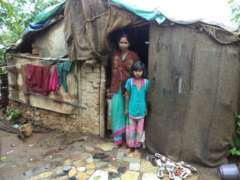 Sakshi & her mother in front of their house