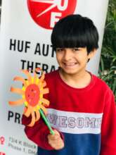 Child flaunting his artwork