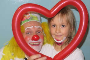A balloon heart and a painted smile.