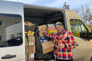 A volunteer unloads humanitarian aid