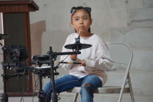 student playing the drums