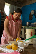 Maria Gonzalez cutting lemons in her store/bakery