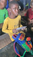 Child with his plastic self-crafted school bag