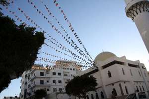 Libyan flags fluttter from a mosque in Tripoli