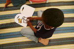 A young boy plays in a special tent run by UNHCR