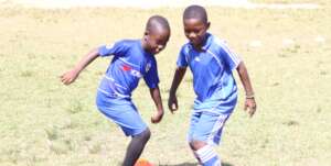 Two boys enjoying the beautiful game