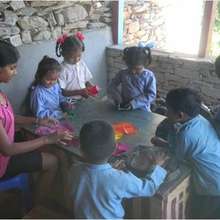 Laxmi Teaching Origami to Nepali Children