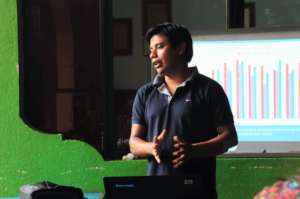Tomas presents WASH results at an staff meeting