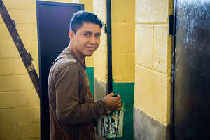A worker paints the bathrooms in Totolya