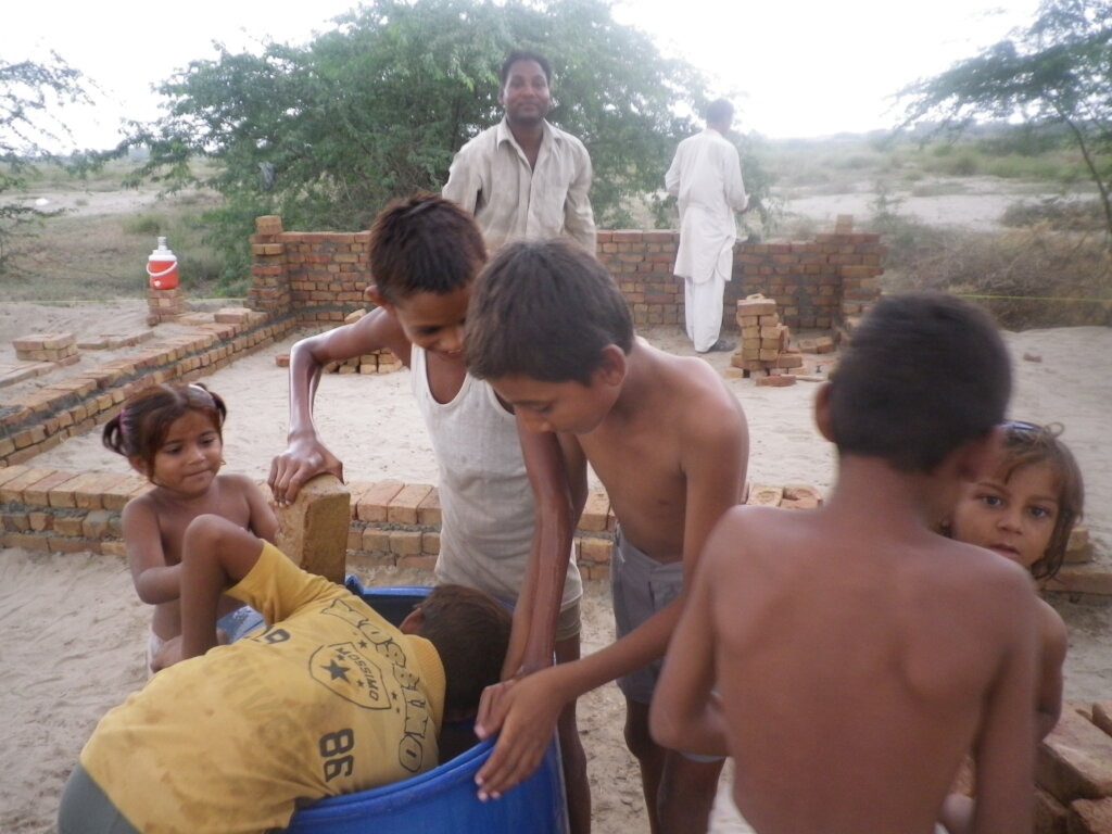 Children helping build their future home